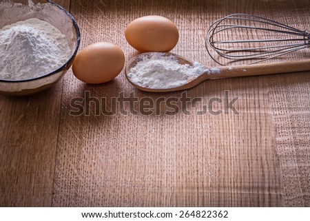 organized copyspace flour in spoon and bowl eggs on wooden board food and drink still life