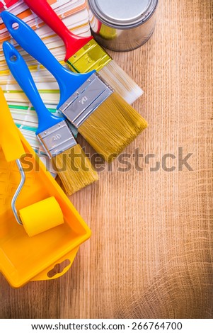 painting tools paint brush roller tray can color palette on wooden board