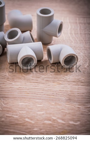 Somposition Of Polypropylene Pipe Fittings On Wooden Board
