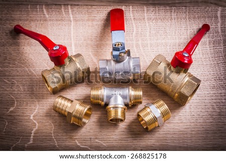 Composition Of Plumbing Tools Brass Pipe Connectors On Wooden Board
