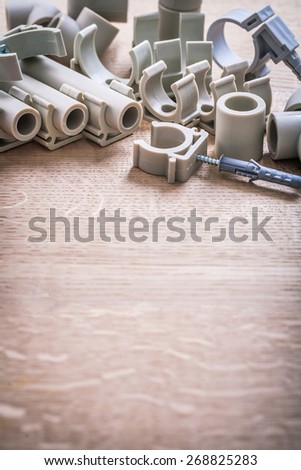 Organized Copyspace Big Composition Polypropylene Fixators And  Pipe  With Clips On Wooden Board