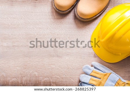 horizontal version organized copyspace working boots helmet gloves On Wooden Board
