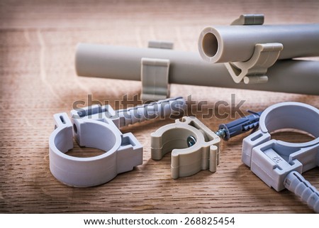 Composition Polypropylene Fixators And  Pipe  With Clips On Wooden Board