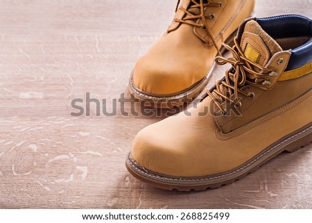 horizontal view very close up view two working shoes On Wooden Board