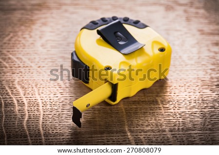 yellow tape measure on wooden board construction concept