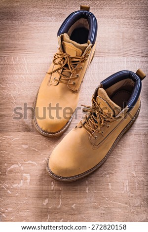 two work shoes standing on wooden board construction concept