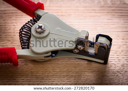 very close up view automatic wire strippers on wooden board