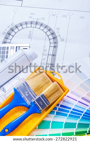 paint brushes and rolls of blueprints