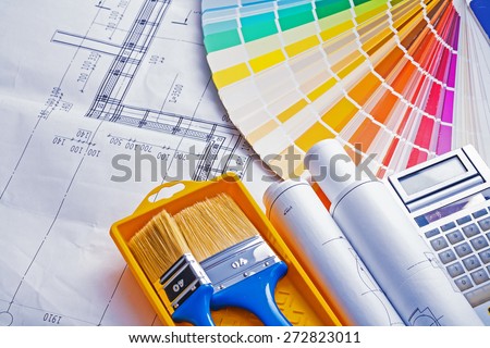 set of painting tools paint brushes in tray rolls blueprints color palette calculator