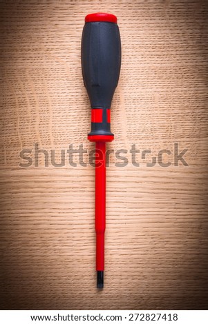 aerial view electric insulated red screwdriver on wooden board