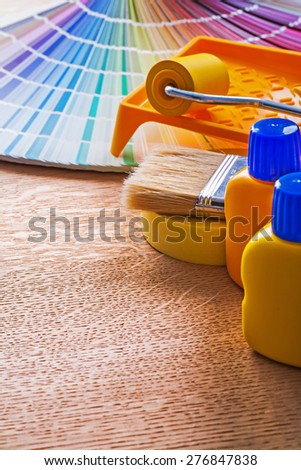 Pantone fan and house improvement paint tools on wooden board construction concept