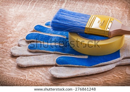 Set of safety gloves with paint brush on duct tape maintenance concept