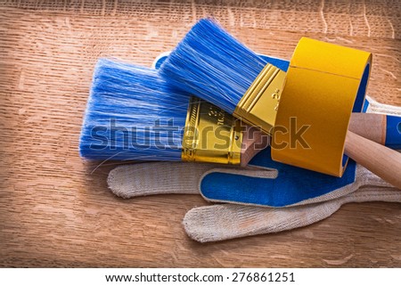 Set of protective gloves with paint brushes in duct tape maintenance concept