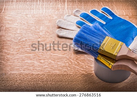 Paint brushes on duct tape and protective gloves construction concept