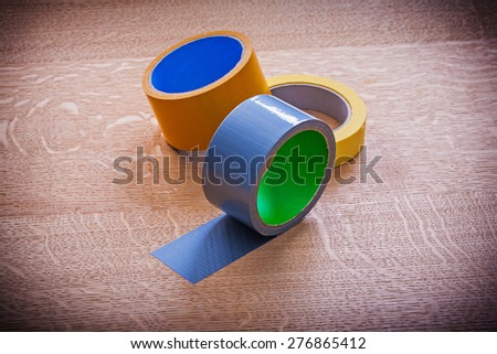 Group of duct tapes on vintage wood board maintenance concept