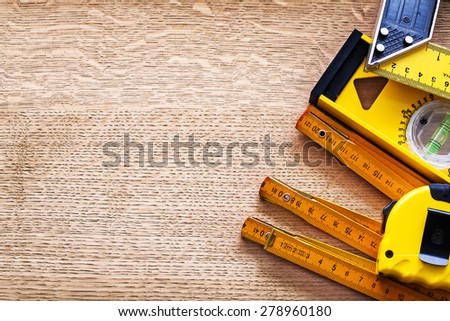 Working tools of measurement on oaken wooden board maintenance concept