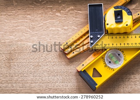 Working tools of measurement on oaken wooden board construction concept