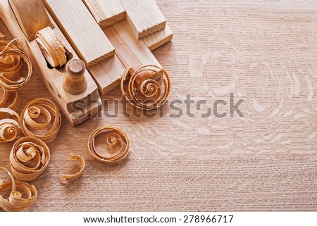 joinery composition old fashioned woodworkers plane and planks shawings on wooden board with copyspace