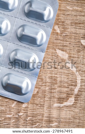 blister pack with medical pills on wooden board