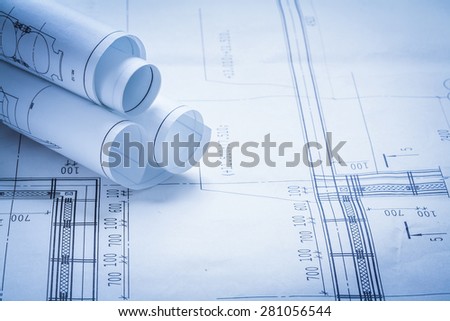 Some rolled up construction drawings building and architecture concept