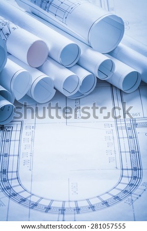Pile of rolled up construction plans building and architecture concept