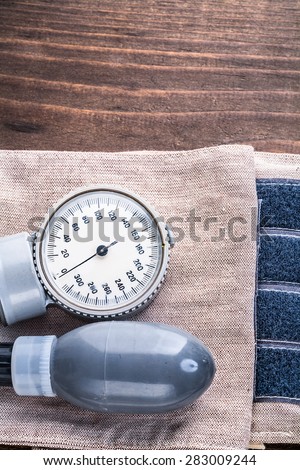 medical tools blood pressure monitor on wooden board