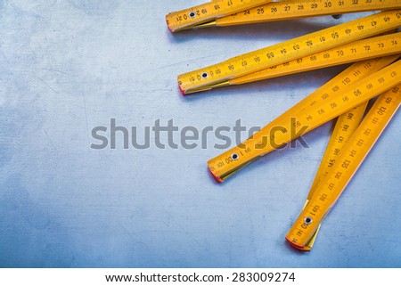 Copy space image of wooden meter on metallic background construction concept