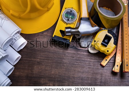 Construction drawings and set of building objects on vintage pine wooden board maintenance concept