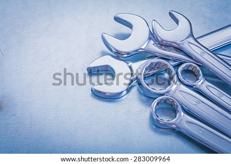 Steel open-end wrenches and flat spanners on metallic background construction concept
