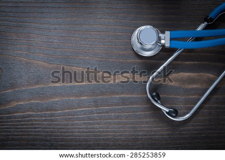 Wooden vintage board with blue medical diagnostic device medicine concept