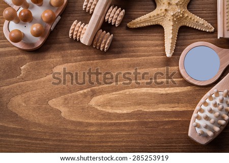 Wooden massagers looking glass starfish and scrubbing brush on pine vintage board sauna concept