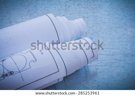 Rolled construction drawings on metallic background horizontal view building and architecture concept