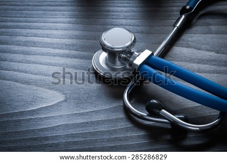 Medical stethoscope on wooden board horizontal version medicine concept