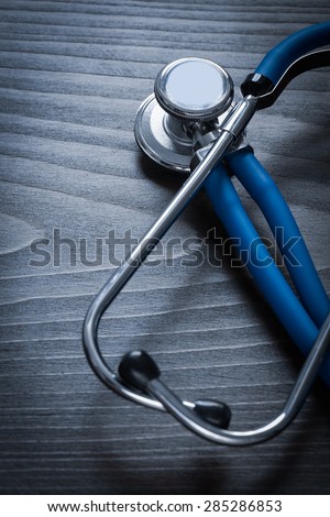 Medical diagnostic tool on wooden background vertical view medicine concept