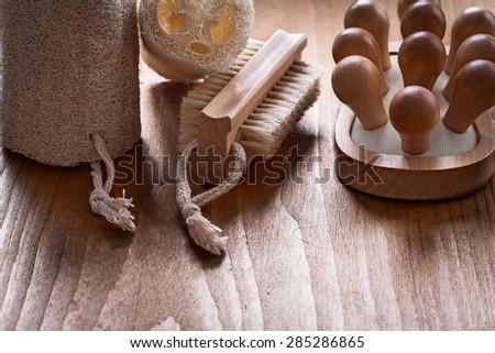 Scrubbing brush loofahs and back massager on pine vintage wood board healthcare concept