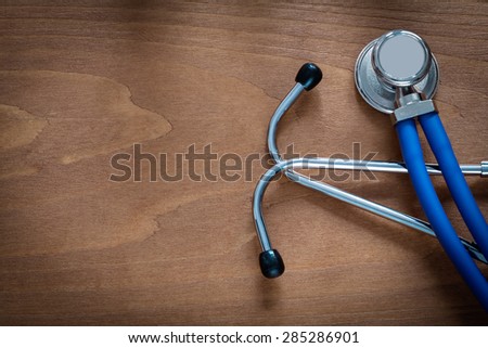 Horizontal view of stethoscope for medical check up on pine vintage wooden board medicine concept