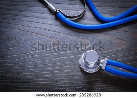 Medical stethoscope on vintage wooden board medicine concept