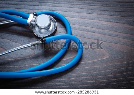 Medical stethoscope on wooden board medicine concept