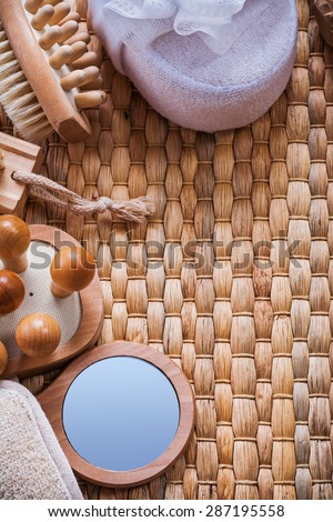 Vanity mirror wooden massagers nail brush and soft bath sponges on wicker background sauna concept