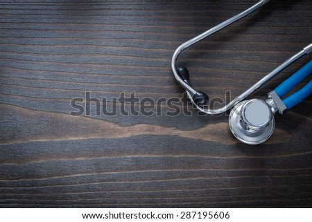 Wooden vintage board with blue medical stethoscope horizontal view medicine concept