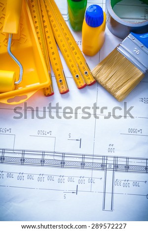Construction drawing with paint objects household tape and wooden meter maintenance concept.