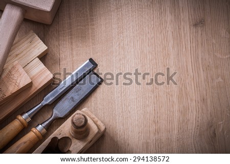 Copy space image of lump hammer planer metal firmer chisels and wooden stud on wood board construction concept.