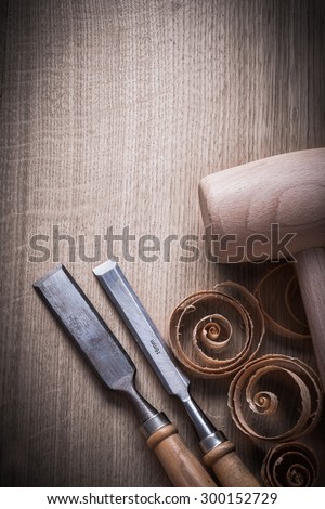 Wooden mallet shavings carpenterÃ?ÃÂ¢ÃÂ¢?ÃÂ¬ÃÂ¢?ÃÂ¢s firmer chisels on wood surface construction concept.
