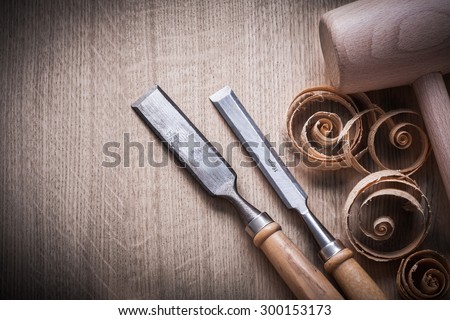 Planing chips wooden mallet carpenterÃ?Â¢Ã¢?Â¬Ã¢?Â¢s flat chisels on wood surface construction concept.