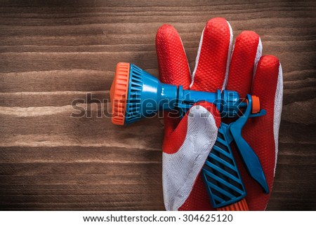 Safety glove and water hose nozzle agriculture concept.