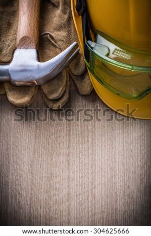 Hammer goggles leather protective gloves hard hat vertical version.