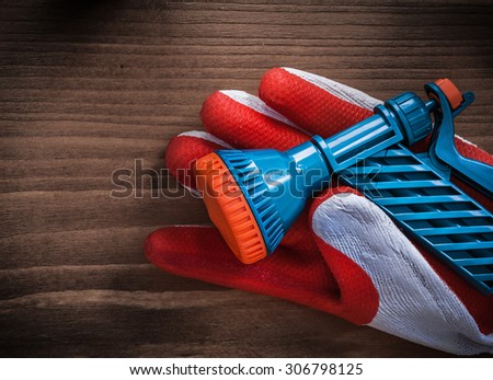 Gardening glove and water spray nozzle agriculture concept.