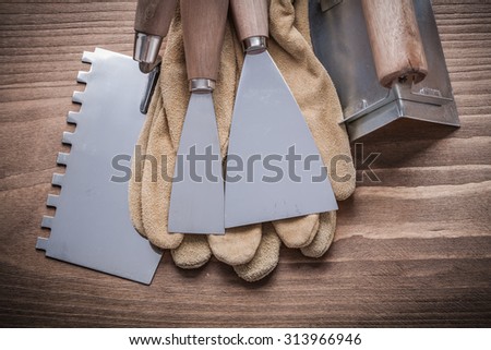 two paint scrapers putty knifes working gloves angle former.