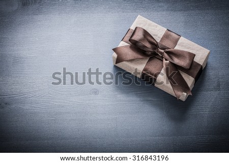 Wrapped present box on vintage wooden board holiday concept.