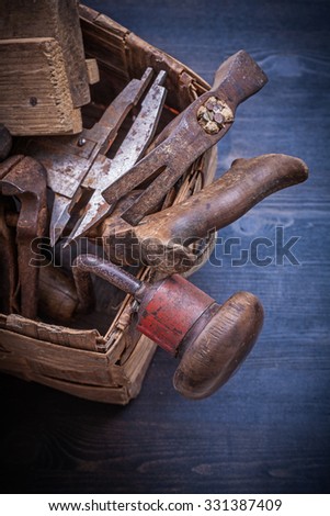 Group of vintage messy tools in wicker box construction concept.